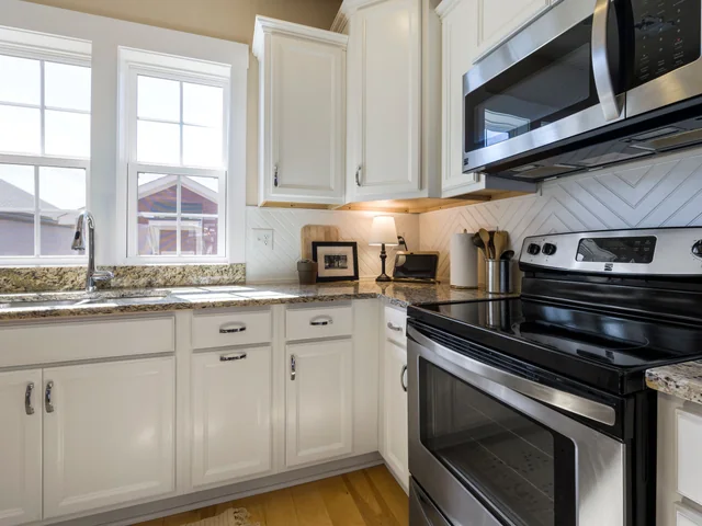 White shaker cabinets with a stainless range