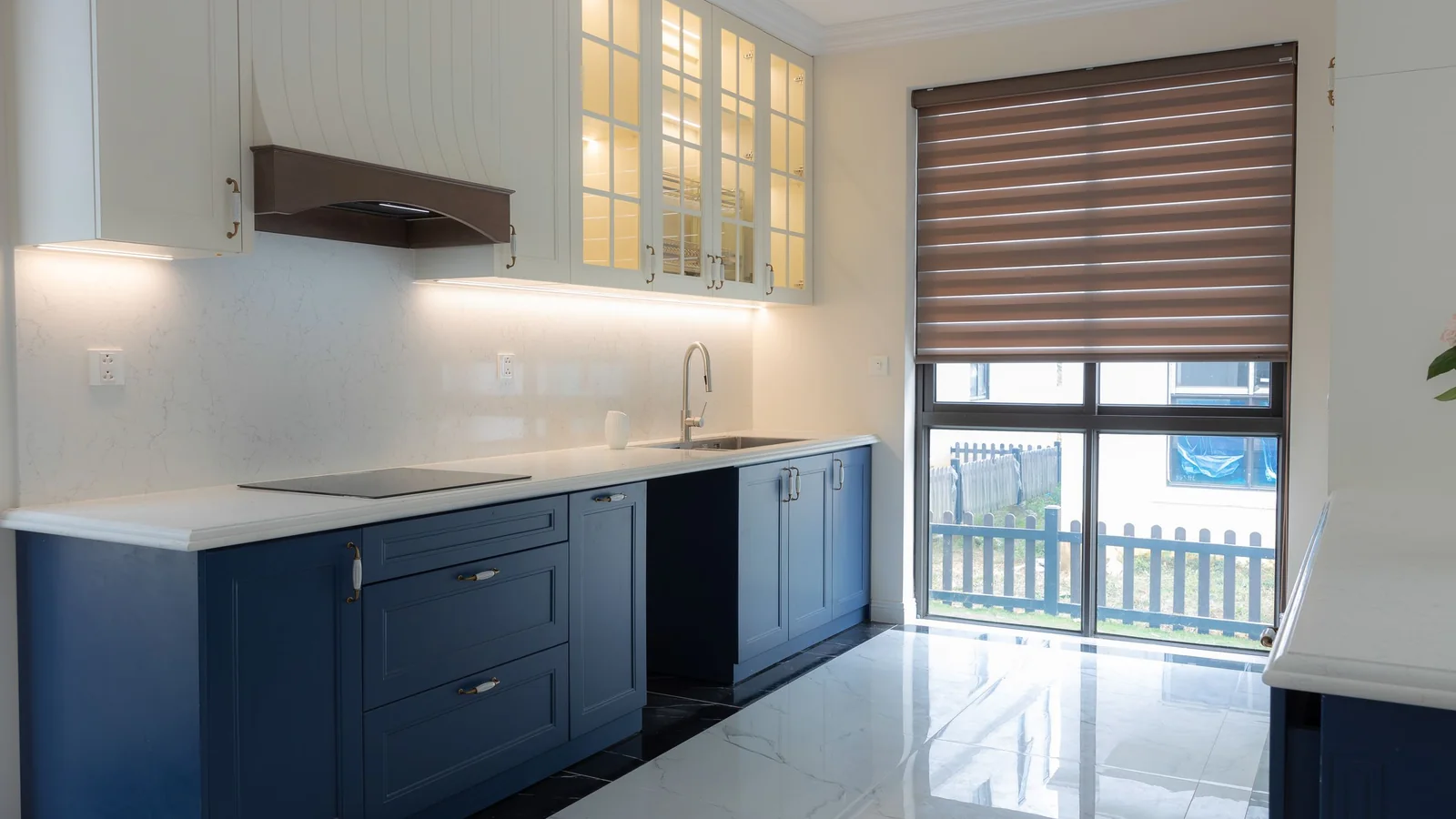 Kitchen with cabinet doors sprayed in a smooth painted finish and new hardware