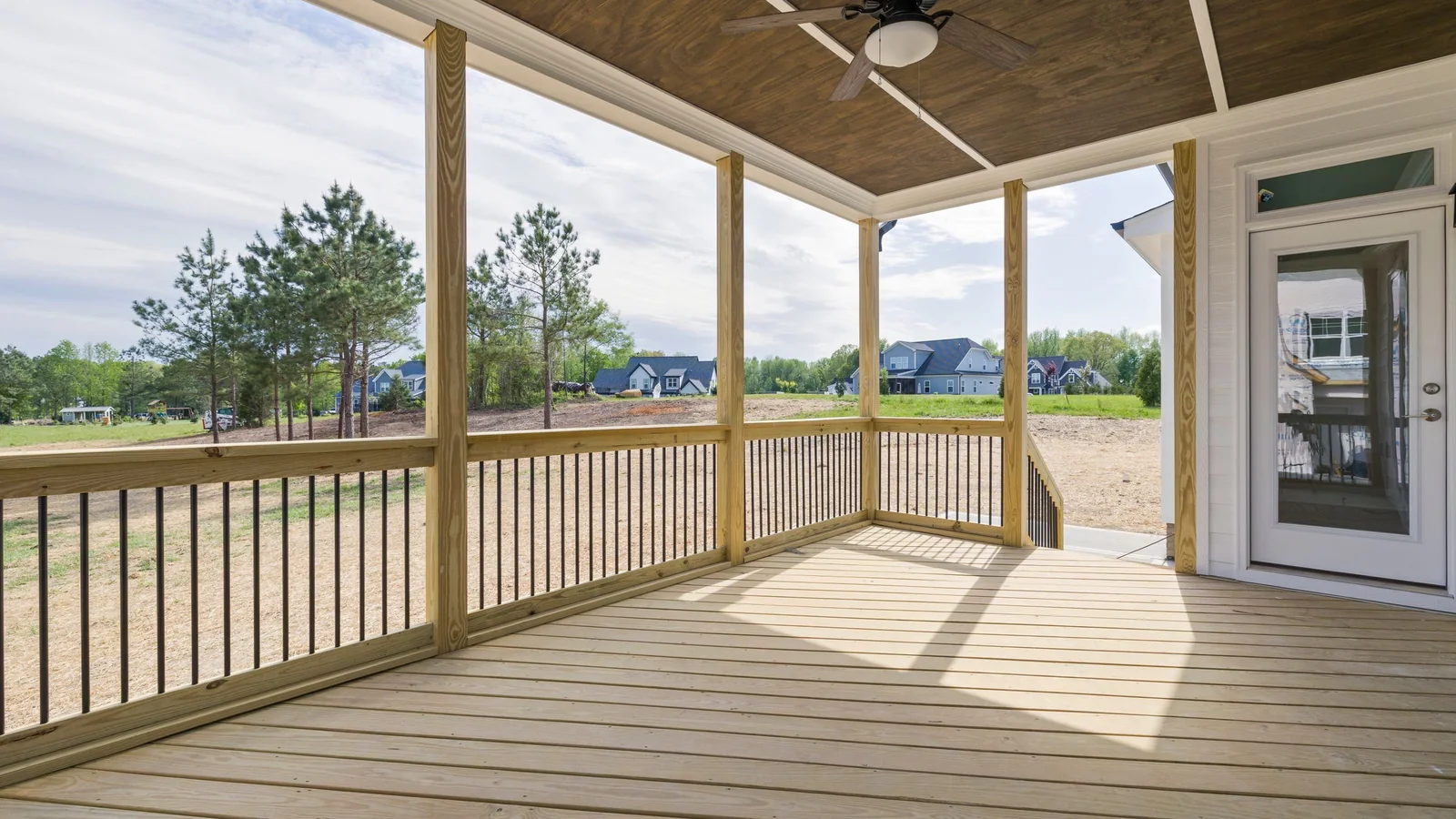 Wood deck boards and railings freshly stained a warm brown tone
