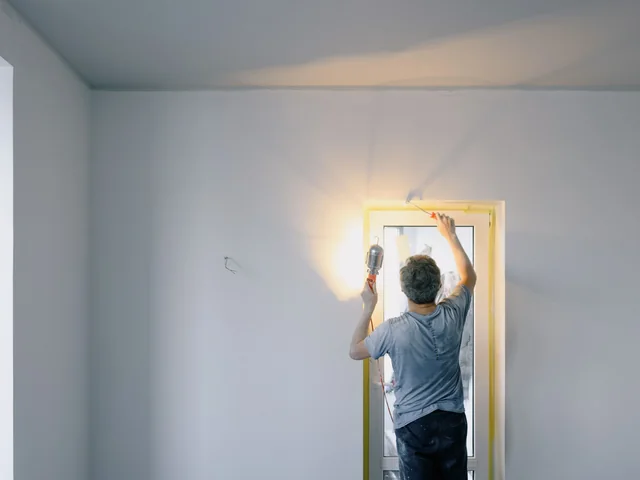A painter brushing a door frame