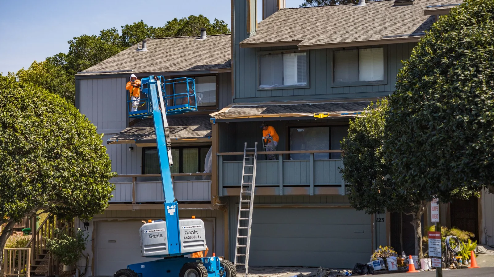Two-story house exterior with newly painted siding and trim on a sunny Colorado day